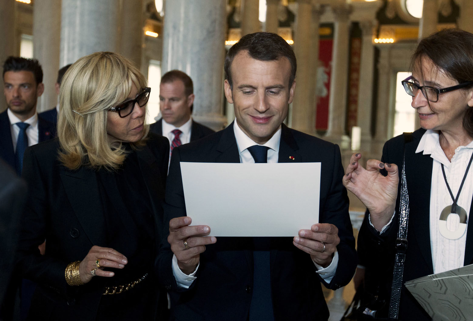 French President Emmanuel Macron and his wife Brigitte read a document during their visit to the Library of Congress on Wednesday, April 25, 2018, in Washington. (AP Photo/Jose Luis Magana)