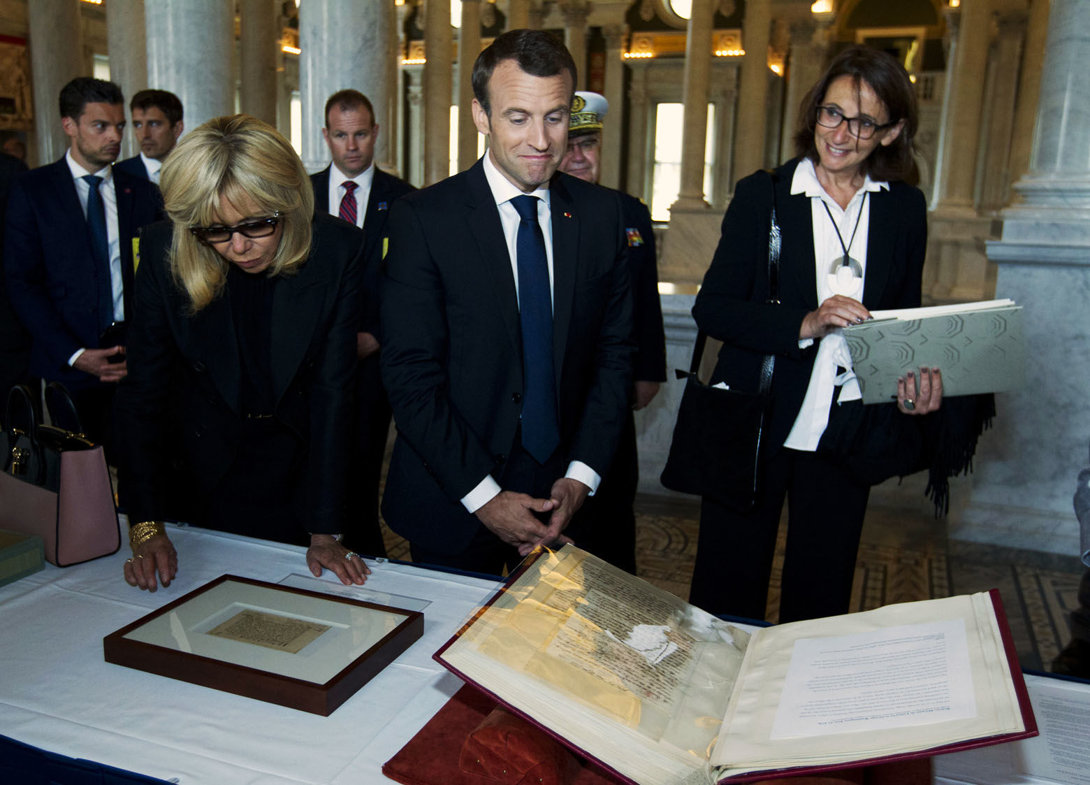 French President Emmanuel Macron and his wife Brigitte read a document during their visit to the Library of Congress on Wednesday, April 25, 2018, in Washington. ( AP Photo/Jose Luis Magana)