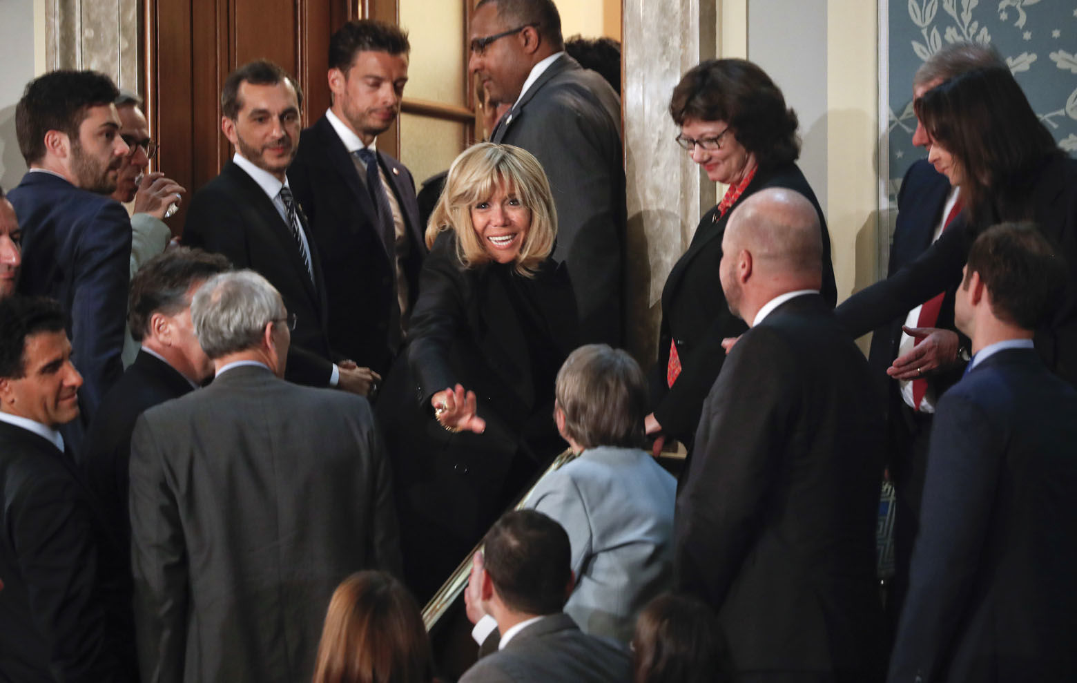 Brigitte Macron, center, wife of French President Emmanuel Macron, waves to guests as she prepares to leave after her husband's address to a joint meeting of Congress on Capitol Hill in Washington, Wednesday, April 25, 2018. (AP Photo/Pablo Martinez Monsivais)