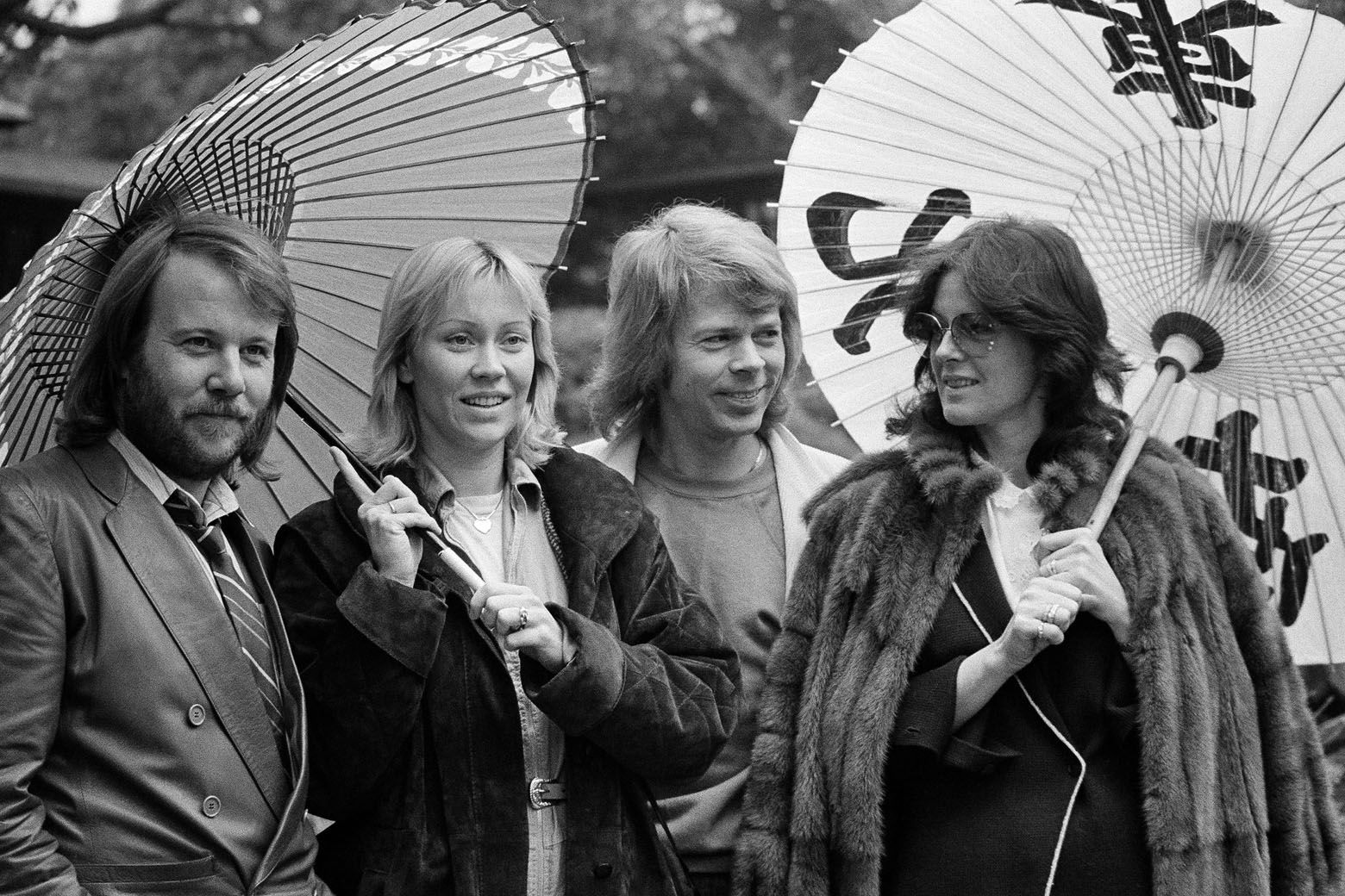 FILE - In this March 14, 1980, file photo, the four members of the Swedish pop group ABBA hold Japanese oil paper parasols in a light rain in the Japanese garden of their hotel in Tokyo. From left: Benny Andersson, Agnetha Faltskog, Bjorn Ulvaeus and Anni-Frid Lyngstad. The members of ABBA are reuniting for a â€œnew digital experienceâ€ next year. The iconic Swedish pop band made the announcement Wednesday, Oct. 26, 2016, but didnâ€&#x2122;t offer much detail. (AP Photo/Tsugufumi Matsumoto)