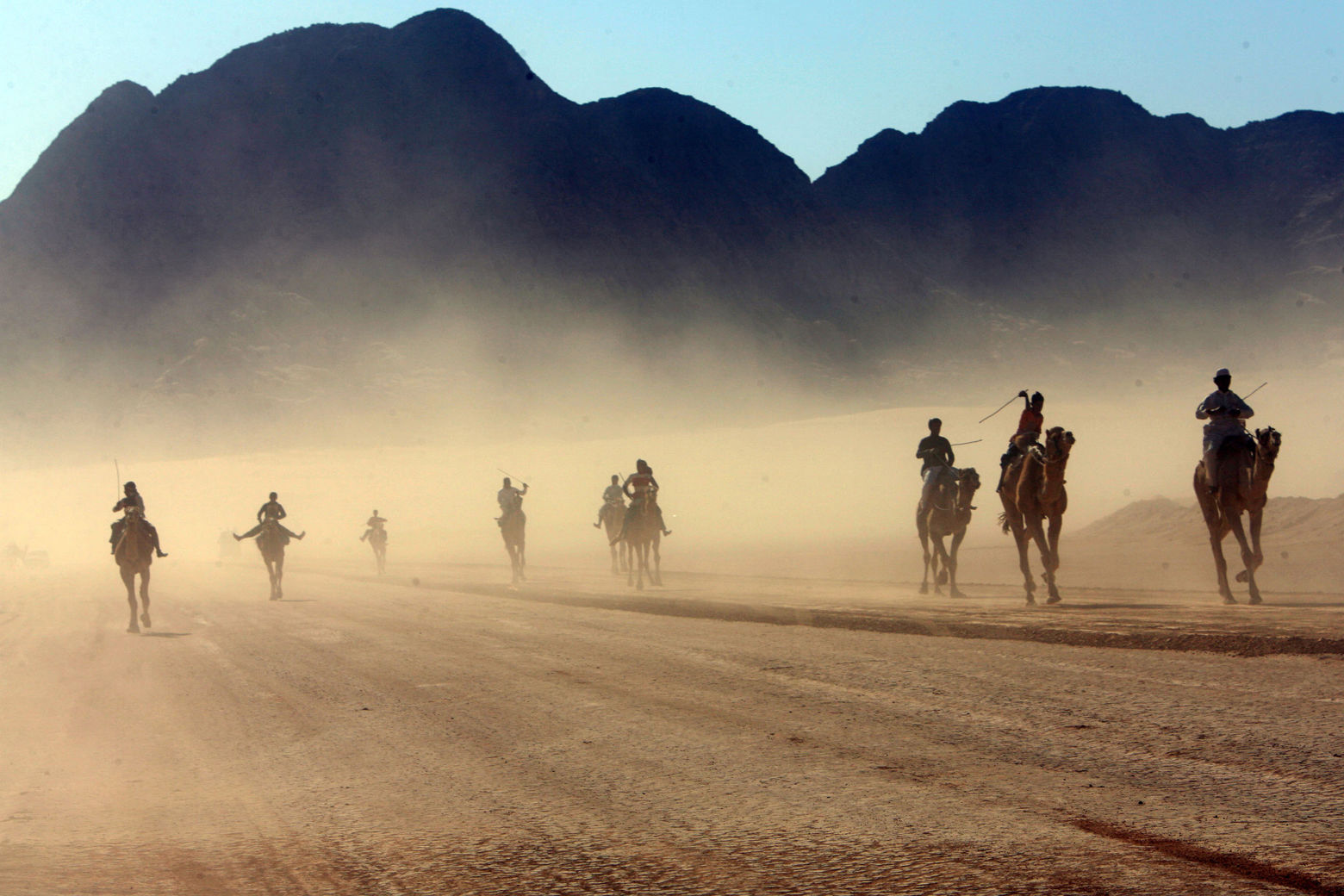 WADI RUM, JORDAN- DECEMBER 14: Beduins children ride their camels during the annual camel race in the desert of Wadi Rum in the south of Jordan December 14, 2007, where competitors from Saudi Arabia, Egypt and Jordan race for 9km in the traditional beduins' sport. (Photo by Salah Malkawi/ Getty Images)