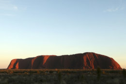 The sun rises over Uluru, Australia, Tuesday, April 22, 2014.  The Duke and Duchess of Cambridge will visit Uluru Tuesday during their three-week tour of Australia and New Zealand, the first official trip overseas with their son, Prince George. (AP Photo/Rob Griffith)