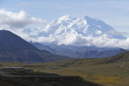 In this photo taken Aug. 26, 2016, sightseeing buses and tourists are seen at a pullout popular for taking in views of North America's tallest peak, Denali, in Denali National Park and Preserve, Alaska. President Barack Obama's administration in 2015 renamed the peak to its Athabascan name in a nod to Alaska Natives. As a  It's not yet clear whether Trump, now the presicandidate for president, Donald Trump tweeted a vow to change the mountain's name back to Mount McKinley.dent-elect, will act. (AP Photo/Becky Bohrer)