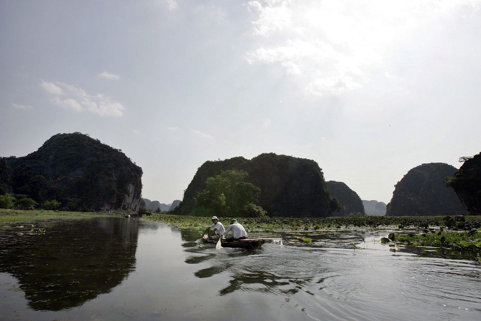 A boat passes through Tam Coc in Ninh Binh Province, about 100 kilometer ( 62 miles) from Hanoi, Vietnam, Wednesday, Sept. 19, 2007. Tam Coc, which means three caves, is also referred to as Halong Bay on Land. Tourists often used boats to explore the caves on the river. (AP Photo/Chitose Suzuki)