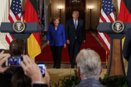 President Donald Trump and German Chancellor Angela Merkel arrive for a news conference in the East Room of the White House, Friday, April 27, 2018, in Washington. (AP Photo/Evan Vucci)