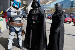Attendees dressed as Boba Fett, Darth Vader, and Kylo Ren from the "Star Wars" movie series arrive at AwesomeCon 2018 at the Walter E. Washington Convention Center in Washington, D.C. (Shannon Finney)