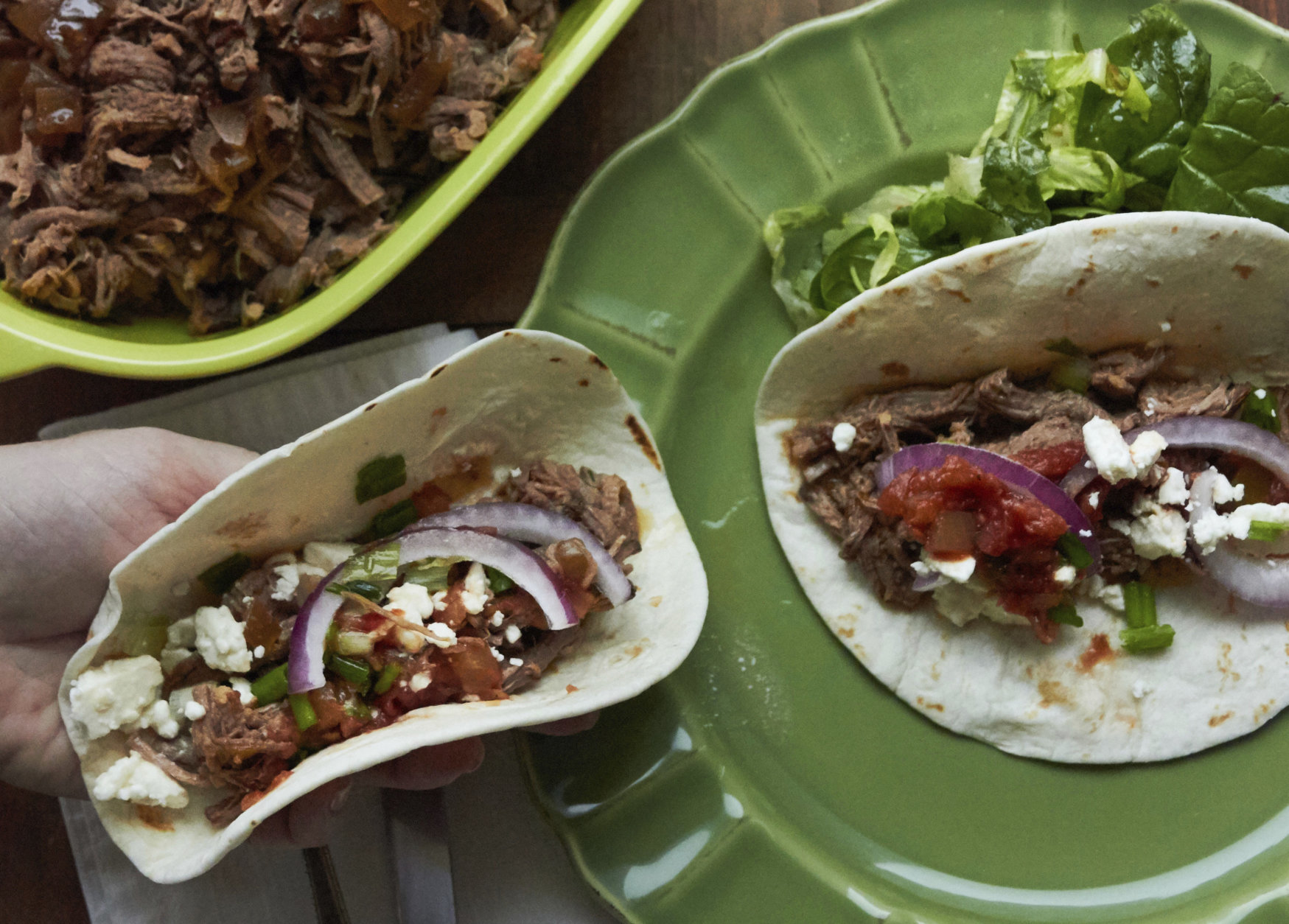 This December 2016 photo shows barbacoa beef tacos in New York. This dish is from a recipe by Katie Workman. (Mia via AP)