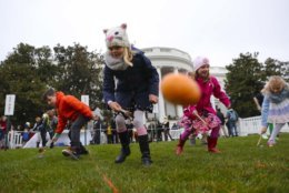 Julia Stimson, 8, from Alexandria, Va., and other children participate in the annual White House Easter Egg Roll on the South Lawn of the White House in Washington, Monday, April 2, 2018. (AP Photo/Pablo Martinez Monsivais)