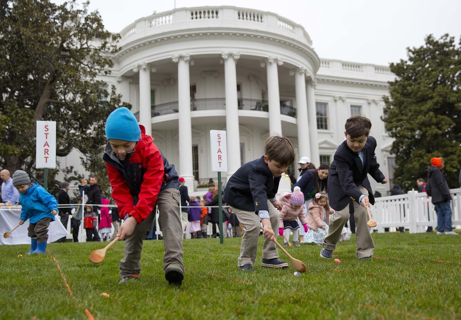 From l-r., Seamus Menefee, 7, from Burke, Va., Skye Kennedy, 5, and his brother Jack Kennedy, 8, both from Montclair, N.J., participates in the annual White House Easter Egg Roll on the South Lawn of the White House in Washington, Monday, April 2, 2018. (AP Photo/Pablo Martinez Monsivais)