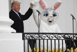 President Donald Trump and the Easter Bunny, after speaking to the crowd on the Truman Balcony during the annual White House Easter Egg Roll on the South Lawn of the White House in Washington, Monday, April 2, 2018. (AP Photo/Pablo Martinez Monsivais)