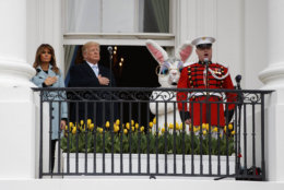 President Donald Trump, first lady Melania Trump and the Easter Bunny listen to the National Anthem with their hands over their hearts on the Truman Balcony at the White House in Washington, Monday, April 2, 2018, during the annual White House Easter Egg Roll. (AP Photo/Carolyn Kaster)