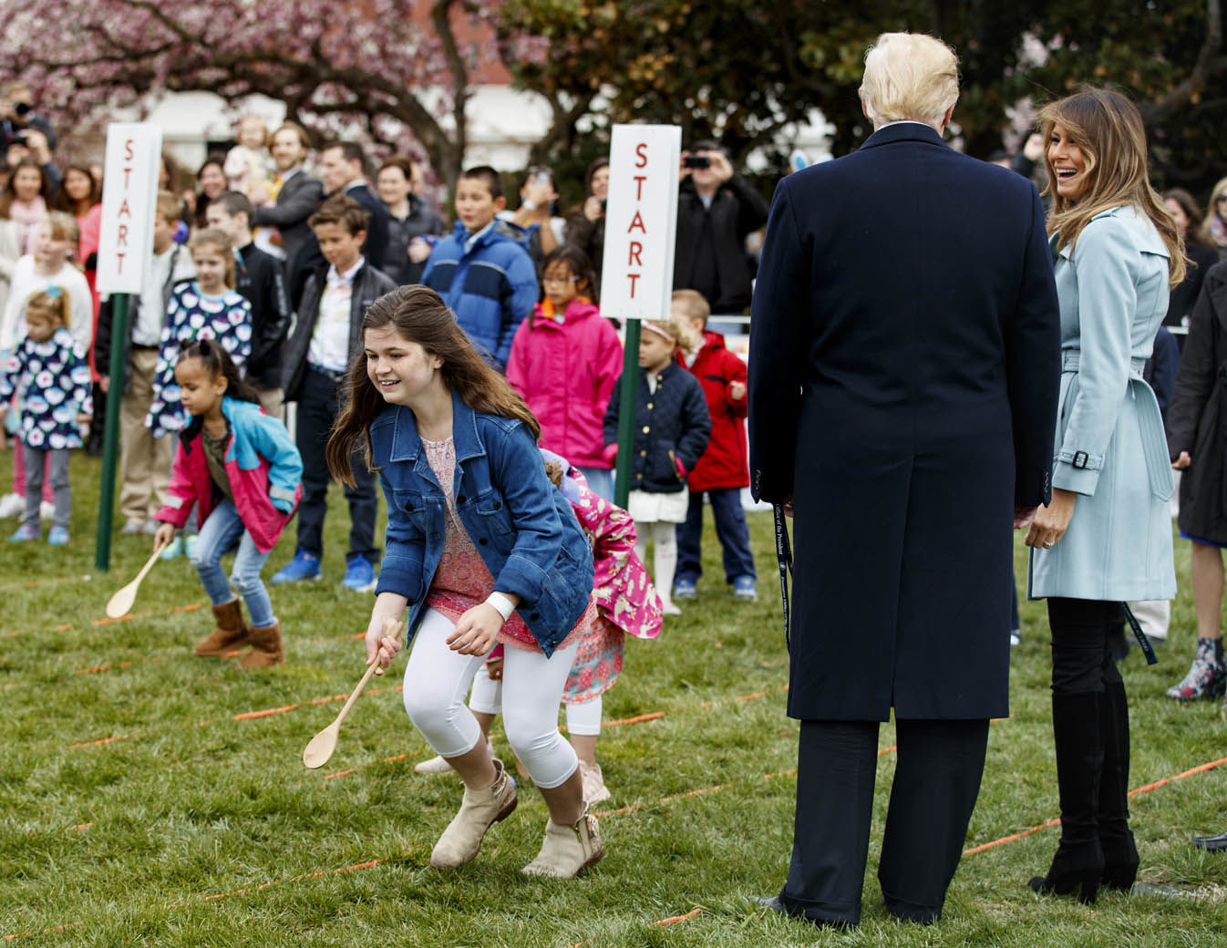 First lady Melania Trump looks to President Donald Trump at the White House in Washington, Monday, April 2, 2018, during the annual White House Easter Egg Roll. (AP Photo/Carolyn Kaster)