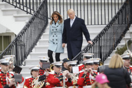 President Donald Trump and first lady Melania Trump walk down from the Truman Balcony during the annual White House Easter Egg Roll on the South Lawn of the White House in Washington, Monday, April 2, 2018. (AP Photo/Pablo Martinez Monsivais)