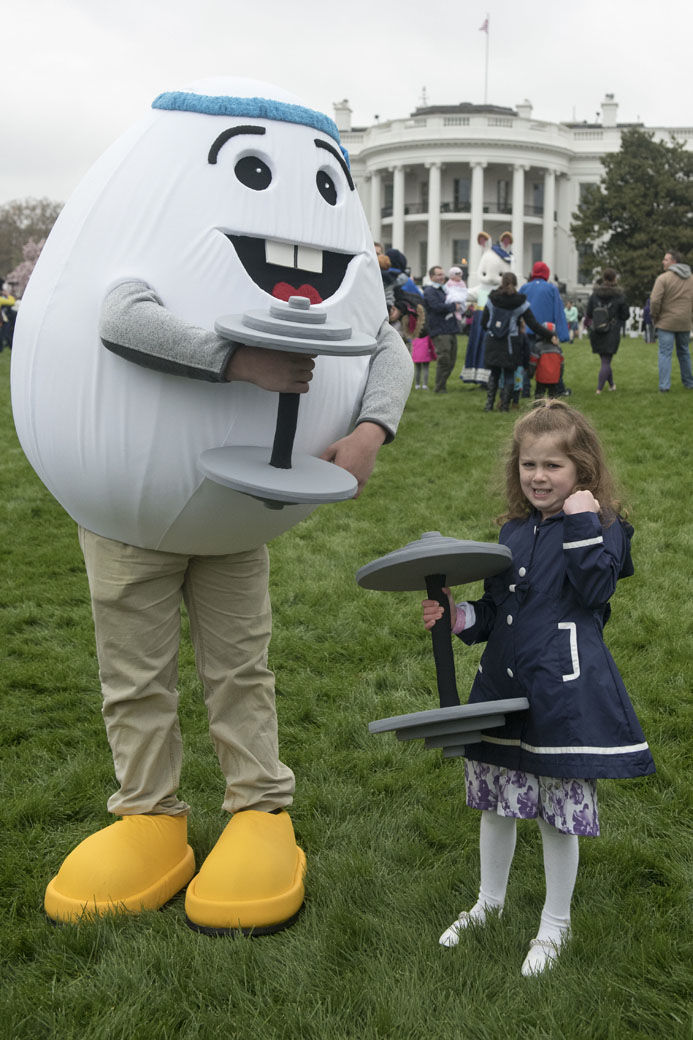 IMAGE DISTRIBUTED FOR AMERICAN EGG BOARD - The Incredible Egg mascot Eggy works out with an attendee of the 2018 White House Easter Egg Roll on the South Lawn on Monday, April 2, 2018, in Washington. (Kevin Wolf/AP Images for American Egg Board)