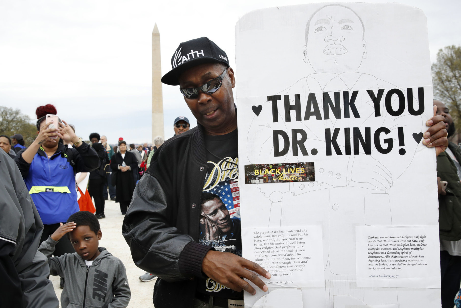 Leonard Patterson, of Manassas, Va., holds a hand made sign thanking Martin Luther King Jr., while attending the A.C.T. To End Racism rally, Wednesday, April 4, 2018, on the National Mall in Washington, on the 50th anniversary of King's assassination. (AP Photo/Jacquelyn Martin)