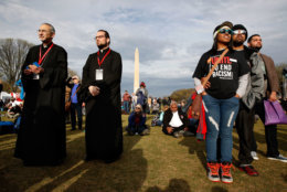 Father Yeprem Kelegian, left, and Father Avedis Kalayjian, both clergy in the Armenian Church, and Cheyanne Friend, center right, with her husband Darin Friend, of Charleston, W.V., attend the A.C.T. To End Racism rally, Wednesday, April 4, 2018, on the National Mall in Washington, on the 50th anniversary of Martin Luther King Jr.'s assassination. (AP Photo/Jacquelyn Martin)