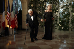 Former Secretary of State Henry Kissinger stumbles as his wife Nancy Kissinger stands, as they arrive for a State Dinner with French President Emmanuel Macron and President Donald Trump at the White House, Tuesday, April 24, 2018, in Washington. (AP Photo/Alex Brandon)