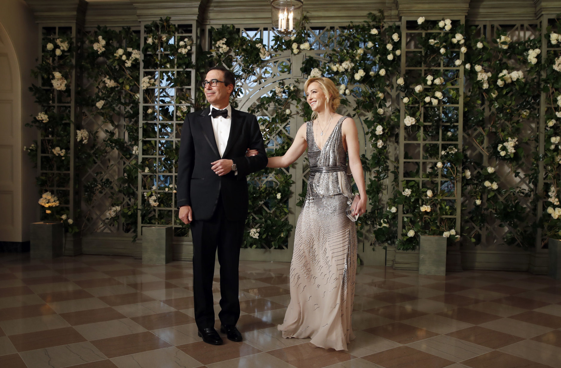 Treasury Secretary Steve Mnuchin and his wife Louise Linton arrive for a State Dinner with French President Emmanuel Macron and President Donald Trump at the White House, Tuesday, April 24, 2018, in Washington. (AP Photo/Alex Brandon)