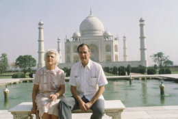 U.S. Vice President George H. W. Bush, right, and his wife Barbara Bush pose in front of the Taj Mahal, the 17th century monument to love was built by a Mughal Emperor Sahajahan in memory of his beloved queen who bore 14 children, Saturday, May 13, 1984, Agra, India. (AP Photo/Sondeep Shankar)