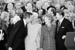 President and Mrs. Ronald Reagan, right, share a moment with Vice President and Mrs. George Bush following the oaths in the Capitol Building in Washington on Monday, Jan. 21, 1985. (AP Photo/Bob Daugherty)