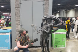 WTOP's Will Vitka battles it out with an alien, or at least someone dressed as an alien, at Awesome Con 2018. (WTOP/Will Vitka)