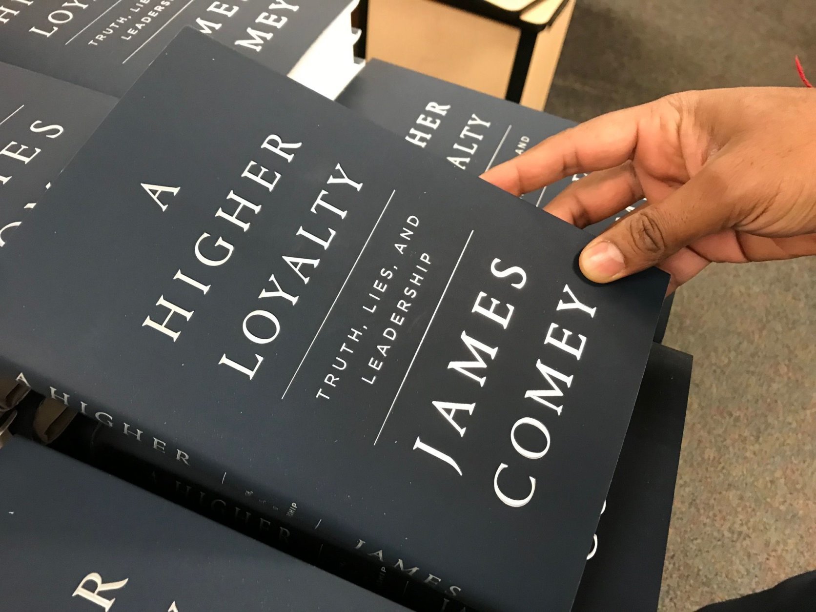 Customer Laurel Reiner said she isn’t buying the book but will read it. 'It has to do with our ethics as Americans – what are we all about as a nation?' (WTOP/Megan Cloherty)