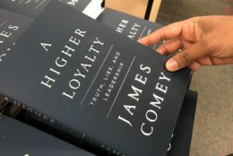 Customer Laurel Reiner said she isn’t buying the book but will read it. 'It has to do with our ethics as Americans – what are we all about as a nation?' (WTOP/Megan Cloherty)