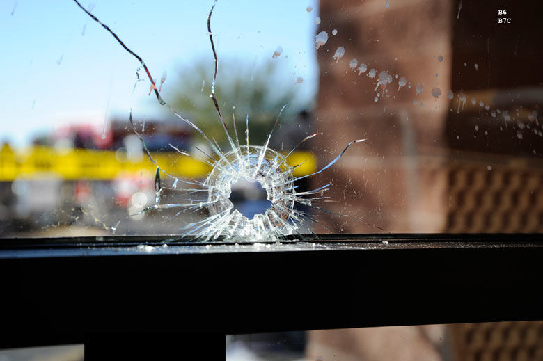 Bullet hole in front window of grocery store where the January 8, 2011 shooting by Jared Lee Loughner occurred in Tucson, Arizona. (Courtesy photo FBI)