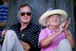 12 Dec 1998:  Former United States President George Bush sits by a tree with wife Barbra Bush as they watch the 1998 Presidents Cup at the Royal Melbourne Golf Course in Melborne, Australia. The International team defeated the U.S.A. team. Mandatory Credit: Nick Wilson  /Allsport