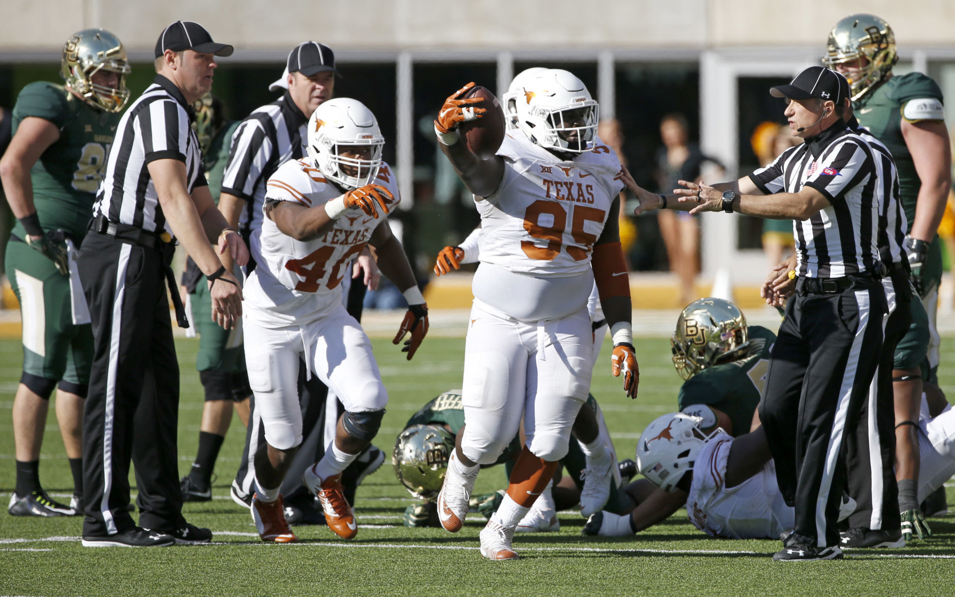 WACO, TX - DECEMBER 5: Poona Ford #95 of theTexas Longhorns celebrates with teammate Naashon Hughes #40 after recovering a fumble against Johnny Jefferson #5 of the Baylor Bears in the fourth quarter at McLane Stadium on December 5, 2015 in Waco, Texas. (Photo by Ron Jenkins/Getty Images)