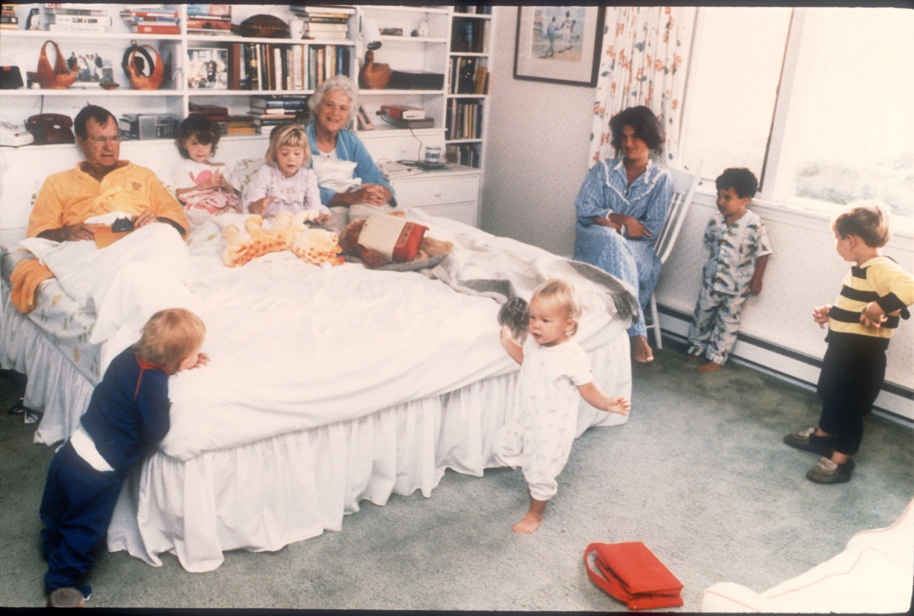 374836 01: George Bush and his wife Barbara sit in their bed as six of their fourteen grandchildren play around them in Washington, D.C. Bush was born June 12, 1924 in Milton, Massachusetts. He attended both Phillips Academy in Andover and Yale University. (Photo by Liaison)