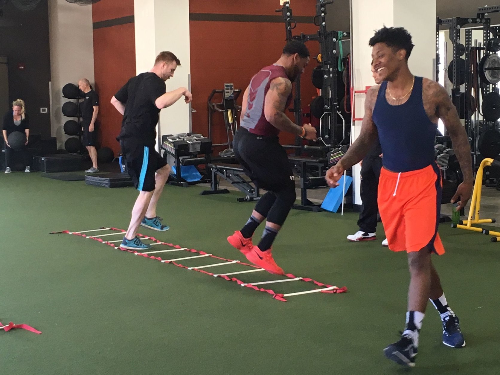 Jessop trains at OneLife Fitness in Brambleton with other athletes including Nigel Johnson (right), who played on the Virginia basketball team as a graduate transfer this season and is looking to improve before the NBA Draft, and Deon Clarke, a former Virginia Tech linebacker who latched onto the Seattle Seahawks practice squad. (WTOP/Noah Frank)