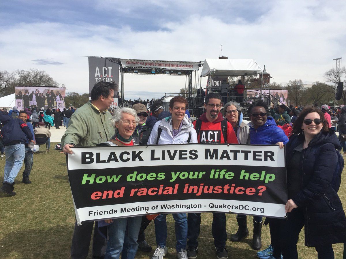 Attendees of the Rally to End Racism display a "Black Lives Matter" banner. (WTOP/Kristi King)