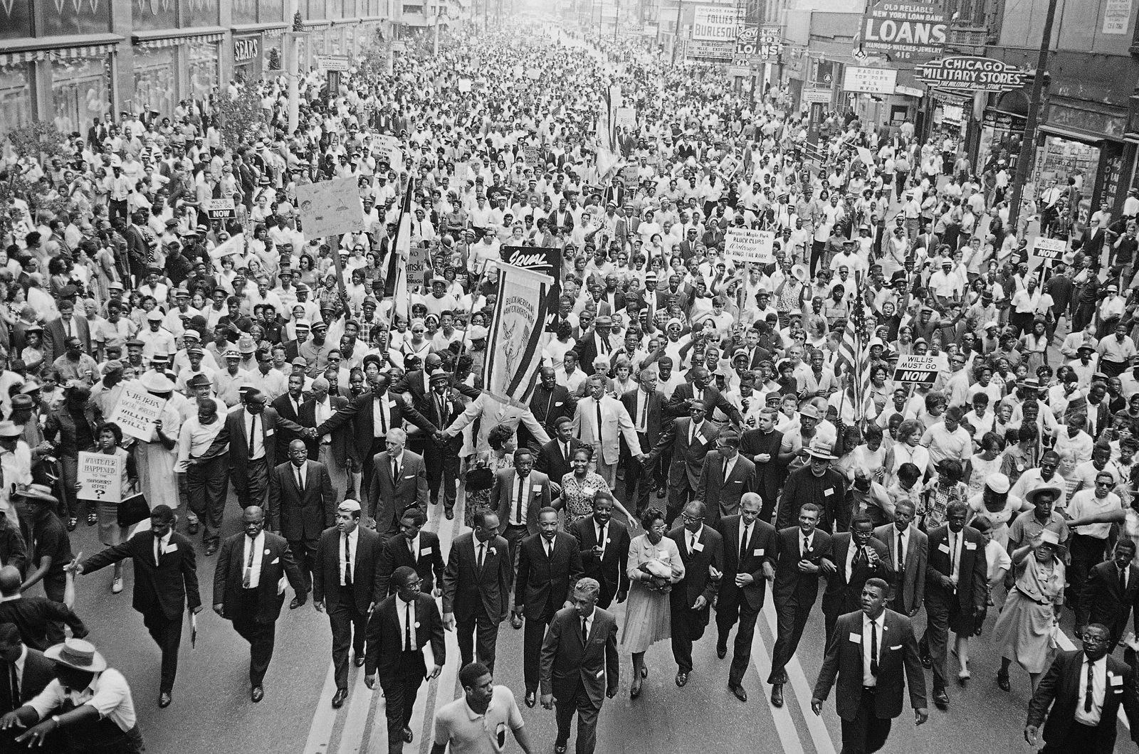 Rev. Martin Luther King Jr., center foreground, walks in vanguard of crowd estimated at more than 10,000 persons who gathered in downtown Chicago, July 26, 1965 to protest segregation in the city's schools. (AP Photo)