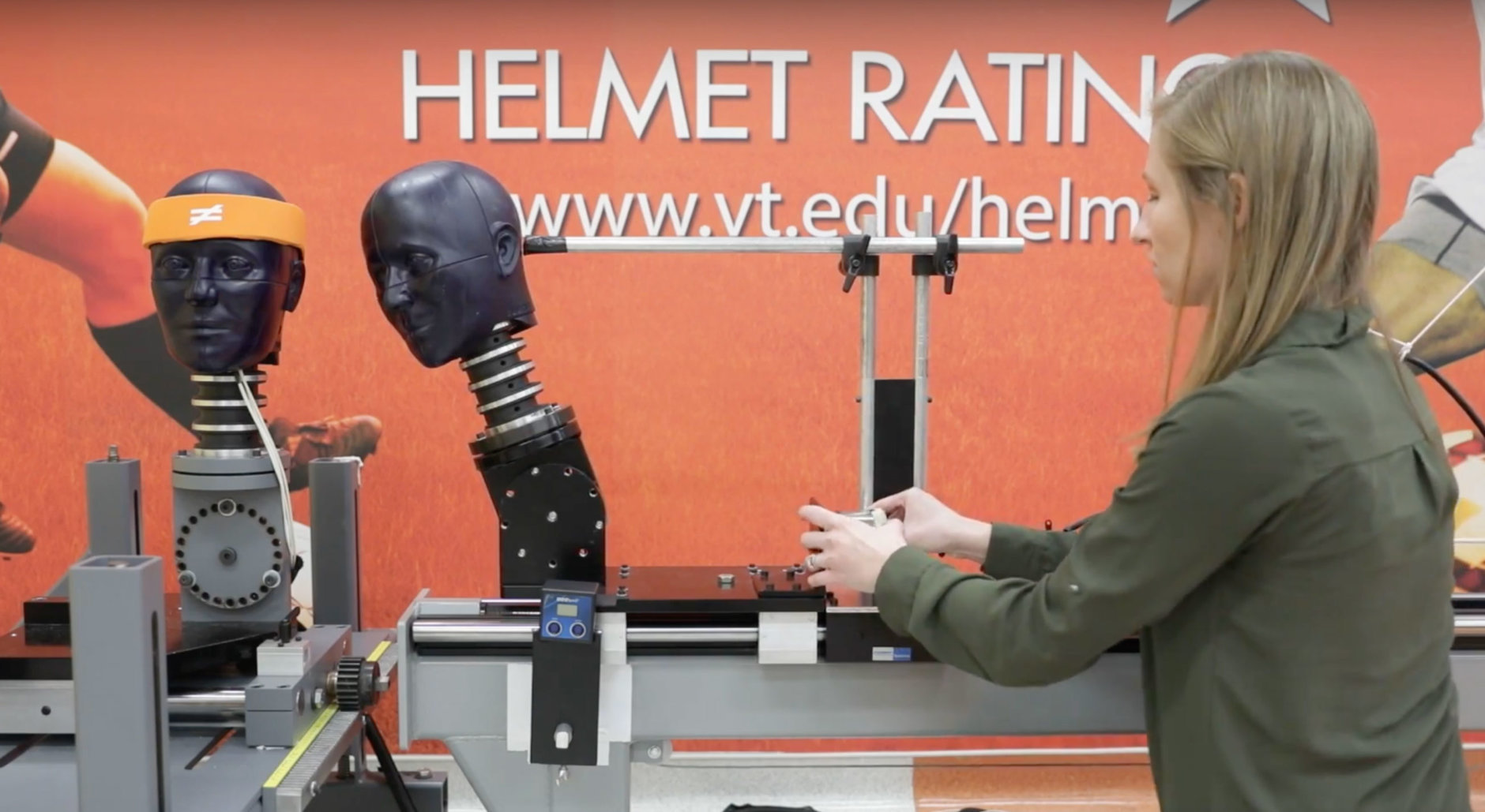 An impact simulator used in the study mimicked two players’ heads colliding at three different impact speeds and two impact locations. The test dummy heads are pictured with Abi Tyson, Virginia Tech Helmet Lab research associate. (Courtesy Virginia Tech)
