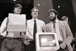 Steve Jobs, left, chairman of Apple Computers, John Sculley, center, president and CEO, and Steve Wozniak, co-founder of Apple, unveil the new Apple IIc computer in San Francisco, April 24, 1984. (AP Photo/Sal Veder)
