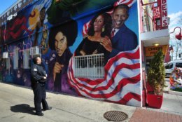 A D.C. Police officer admires the mural outside of Ben's Chili Bowl during a training tour of the U Street corridor. (Courtesy DC Police)