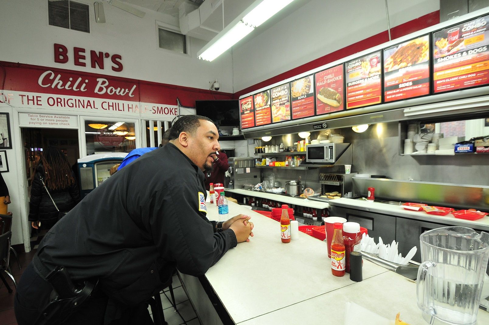 A D.C. Police officer places an order inside Ben's Chili Bowl, taking a break from the 10-hour training incorporating a tour of the U Street corridor and the restaurant integral to the history of the city. (Courtesy DC Police)