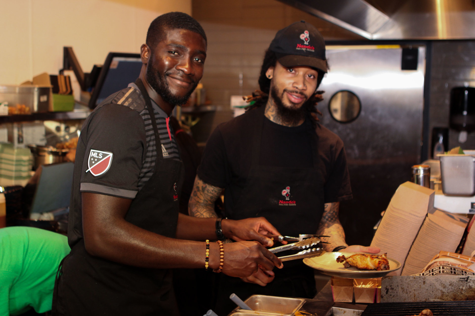 D.C. United player Kofi Opare practices his grilling skills before the April 12 event. (Courtesy Seven Oaks Media)