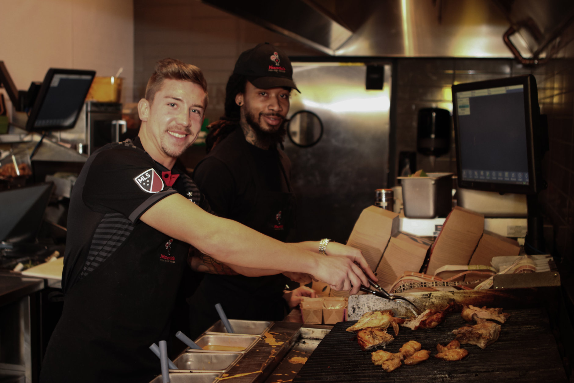 D.C. United player Russell Canouse practices his grilling skills before the April 12 event. (Courtesy Seven Oaks Media)