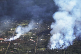 PAHOA, HI - MAY 06:  Fires caused by lava burn in the Leilani Estates neighborhood in the aftermath of eruptions from the the Kilauea volcano on Hawaii's Big Island on May 6, 2018 in Pahoa, Hawaii. A magnitude 6.9 earthquake struck the island May 4. The volcano has spewed lava and high levels of sulfur dioxide gas into communities, leading officials to order 1,700 to evacuate. Officials have confirmed 26 homes have now been destroyed by lava in Leilani Estates.  (Photo by Mario Tama/Getty Images)