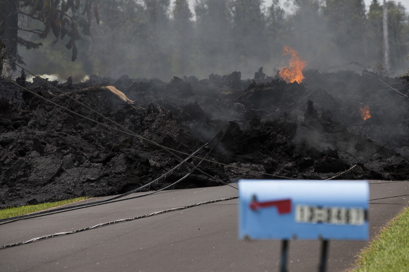 A mail box stands near the lava flow in the Leilani Estates, Saturday, May 5, 2018, in Pahoa, Hawaii. The Hawaiian Volcanoes Observatory said eight volcanic vents opened in the Big Island residential neighborhood of Leilani Estates since Thursday. The Leilani Estates area is at the greatest risk for more lava outbreaks. (AP Photo/Marco Garcia)