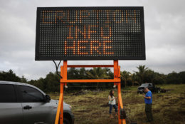 A sign reads 'Eruption Info Here' at a roadblock near volcanic activity on Hawaii's Big Island on May 5, 2018 in Pahoa, Hawaii. A magnitude 6.9 earthquake struck the island May 4 along with new eruptions from the Kilauea volcano. The volcano has spewed lava and high levels of sulfur gas into two nearby communities, leading officials to order 1,700 to evacuate in the area.  (Photo by Mario Tama/Getty Images)