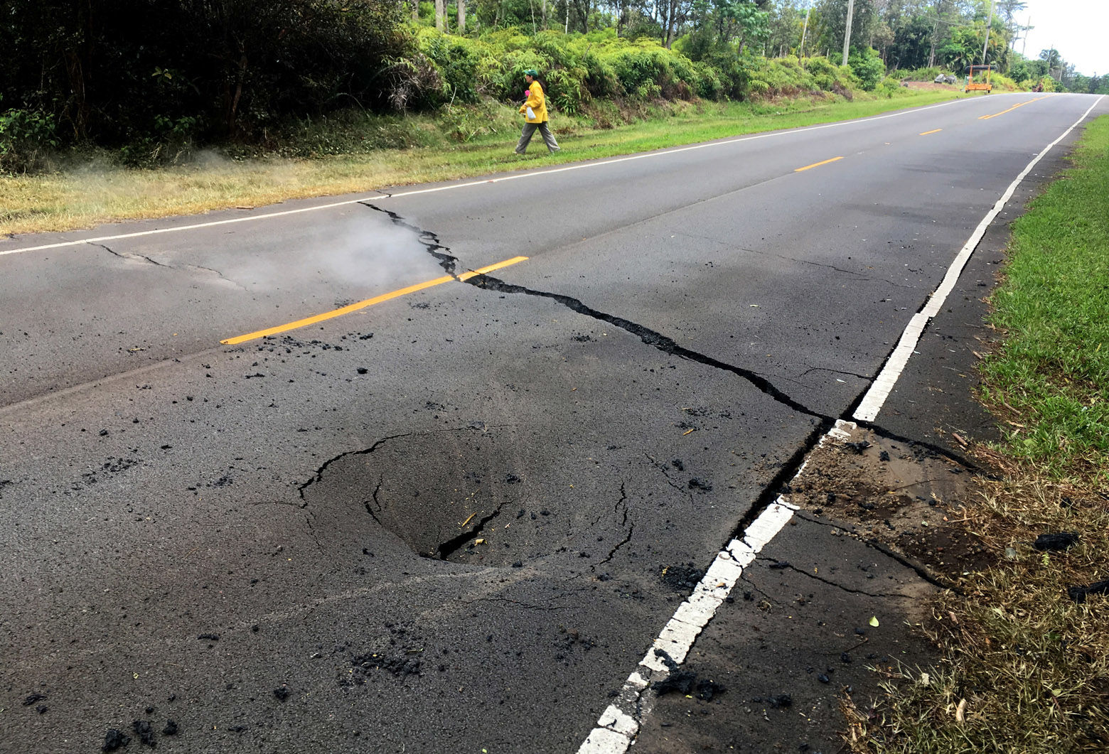 PAHOA, HI - MAY 5: In this handout photo provided by the U.S. Geological Survey, a crack opened on Pohoiki Road just east of Leilani Street after the eruption of Hawaii's Kilauea volcano on May 5, 2018 in the Leilani Estates subdivision near Pahoa, Hawaii. The governor of Hawaii has declared a local state of emergency near the Mount Kilauea volcano after it erupted following a 5.0-magnitude earthquake, forcing the evacuation of nearly 1,700 residents. (Photo by U.S. Geological Survey via Getty Images)