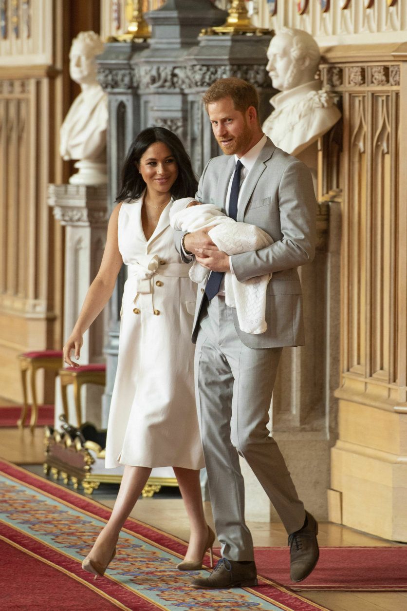 Britain's Prince Harry and Meghan, Duchess of Sussex, arrive for a photocall with their newborn son, in St George's Hall at Windsor Castle, Windsor, south England, Wednesday May 8, 2019. Baby Sussex was born Monday at 5:26 a.m. (0426 GMT; 12:26 a.m. EDT) at an as-yet-undisclosed location. An overjoyed Harry said he and Meghan are "thinking" about names. (Dominic Lipinski/Pool via AP)