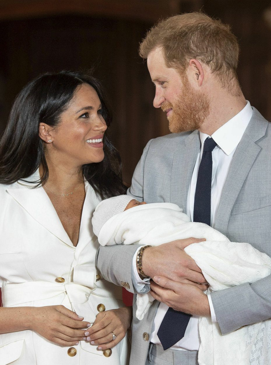 Britain's Prince Harry and Meghan, Duchess of Sussex, during a photocall with their newborn son, in St George's Hall at Windsor Castle, Windsor, south England, Wednesday May 8, 2019. Baby Sussex was born Monday at 5:26 a.m. (0426 GMT; 12:26 a.m. EDT) at an as-yet-undisclosed location. An overjoyed Harry said he and Meghan are "thinking" about names. (Dominic Lipinski/Pool via AP)
