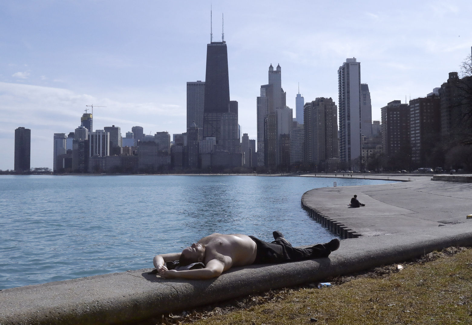 Johnny Perez suns himself in springlike temperatures along Lake Michigan at the North Ave., beach Tuesday, Feb. 27, 2018, in Chicago. (AP Photo/Charles Rex Arbogast)