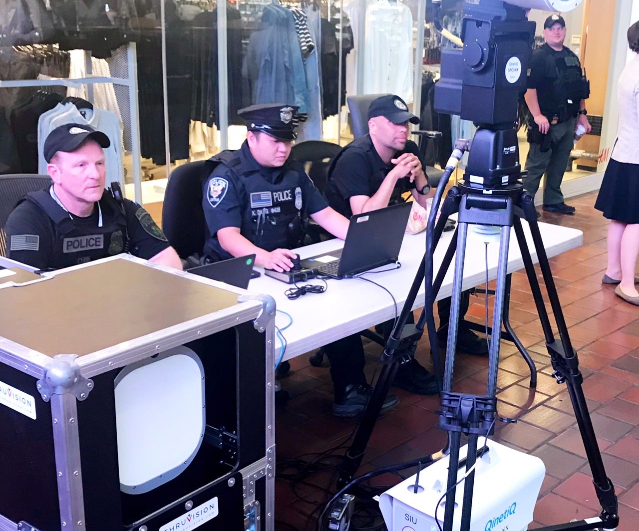 Amtrak police officers viewing laptop computers watched as passengers — including some decoys — walked through a first-floor hallway at Union Station Wednesday. (WTOP/Neal Augenstein)