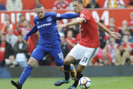 Everton's Wayne Rooney, left, and Manchester United's Nemanja Matic battle for the ball during the English Premier League soccer match between Manchester United and Everton at Old Trafford in Manchester, England, Sunday, Sept. 17, 2017. (AP Photo/Rui Vieira)