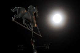 The waning full moon shines on a weather vane during a morning workout at Churchill Downs Wednesday, May 2, 2018, in Louisville, Ky. The 144th running of the Kentucky Derby is scheduled for Saturday, May 5. (AP Photo/Charlie Riedel)
